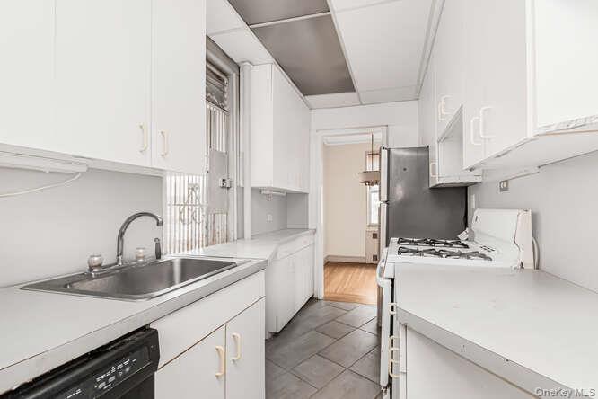 a kitchen with stainless steel appliances a sink a stove and a refrigerator