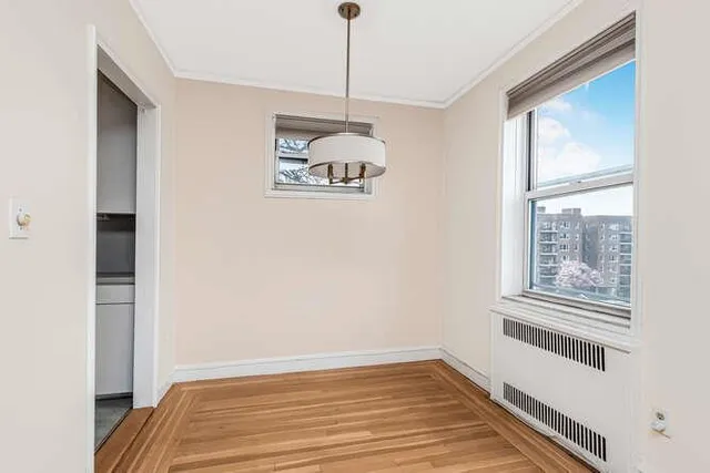a view of a livingroom with wooden floor and a window