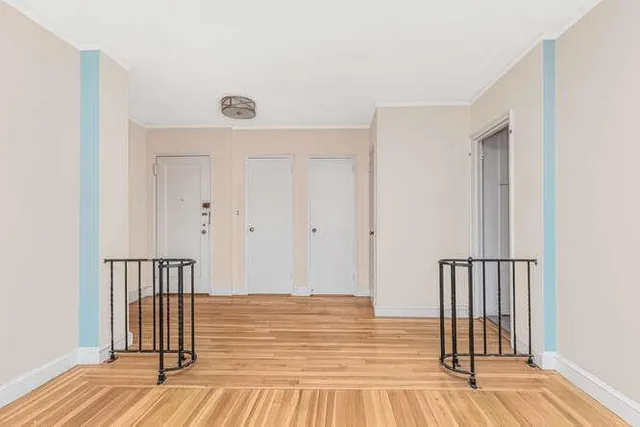 a view of a room with wooden floor and staircase