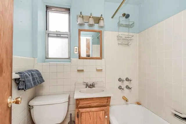 a bathroom with a toilet a sink and a bathtub