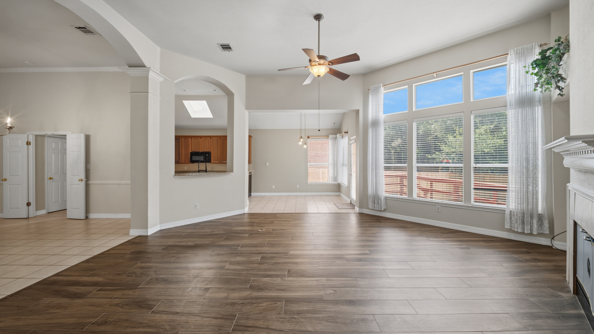 1108 Antelope Ridge Cedar Park, TX 78613 - Photo 3 of 27 A spacious living area features high ceilings, a decorative fireplace, and large windows that invite abundant natural light.