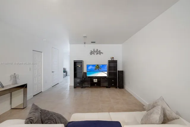 a living room with furniture and a lamp