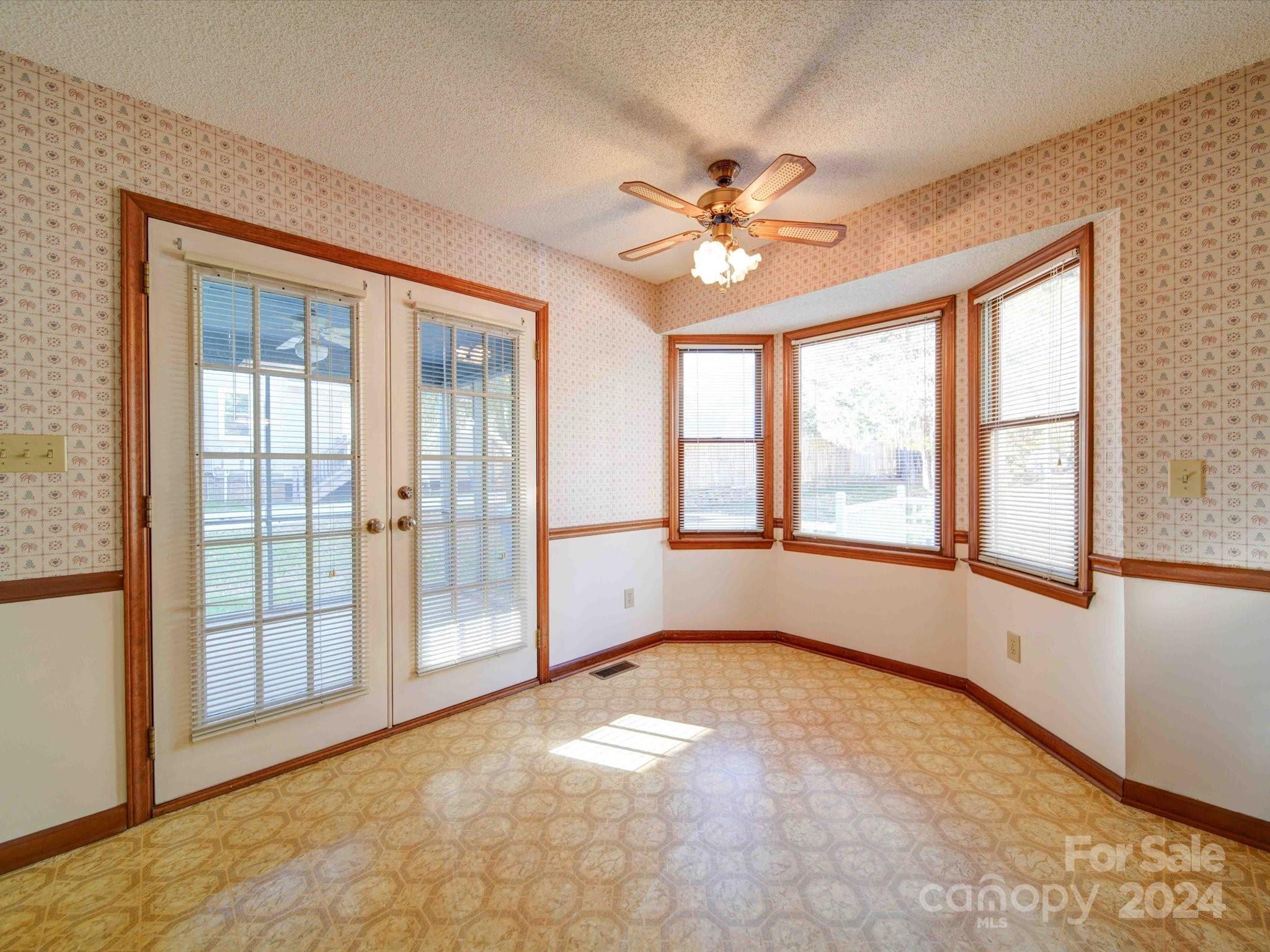 8426 Live Oak Road Harrisburg, NC 28075 - Photo 29 of 46 an empty room with windows and fan