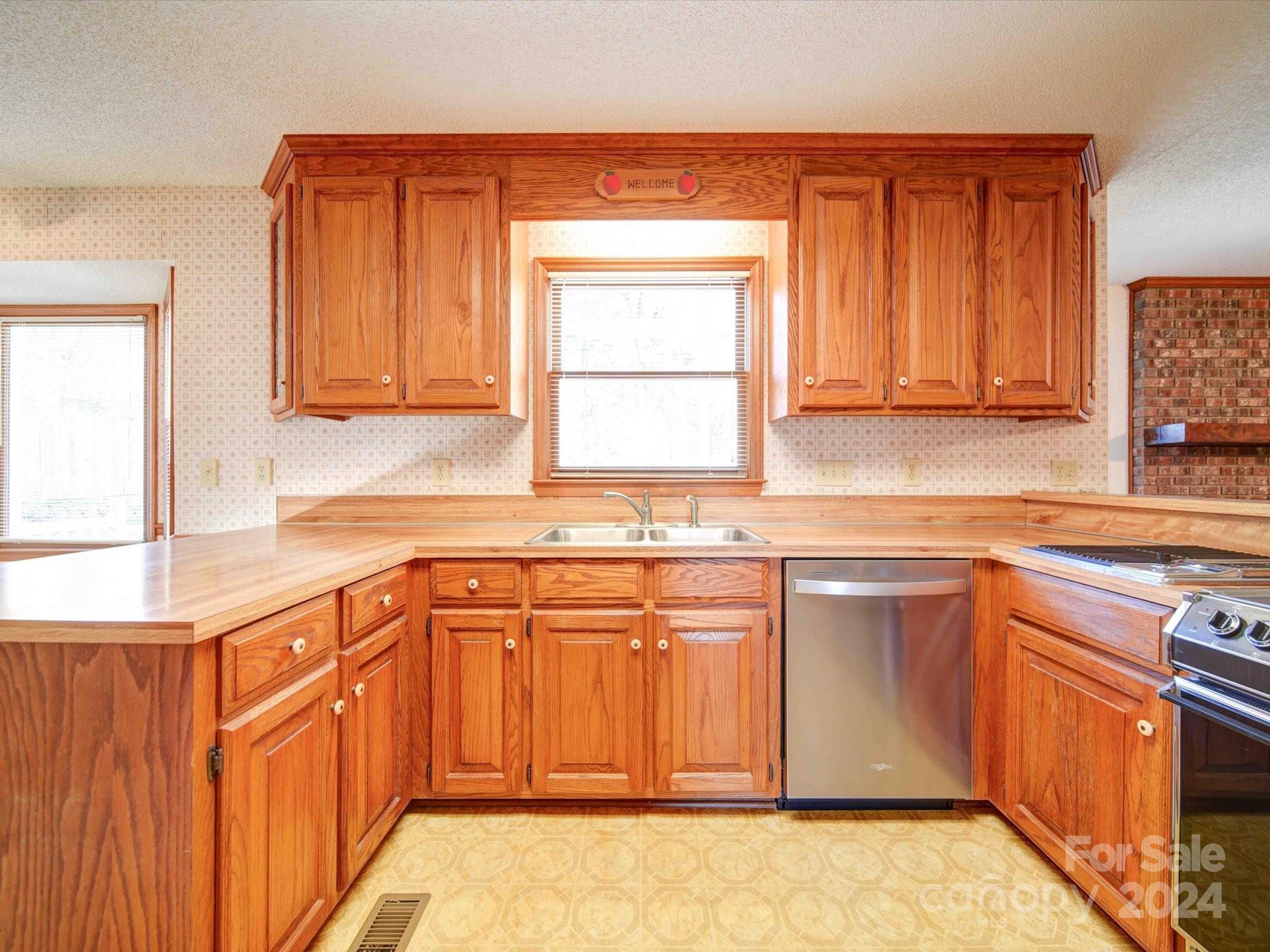 8426 Live Oak Road Harrisburg, NC 28075 - Photo 32 of 46 a kitchen with stainless steel appliances granite countertop a sink stove and cabinets
