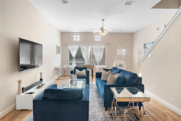 a living room with furniture a rug and a flat screen tv