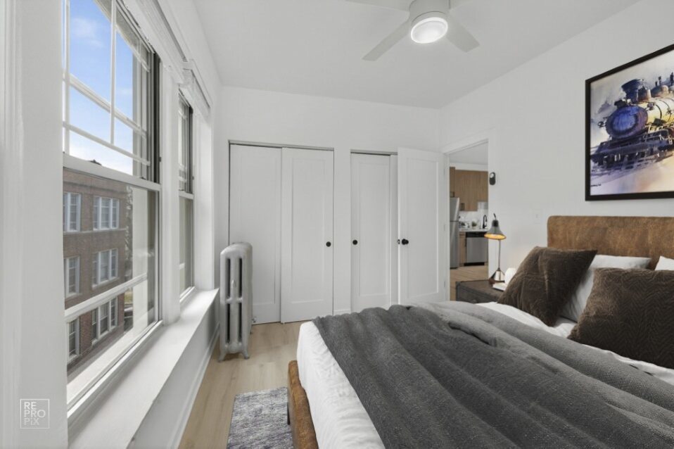 6975 North Bell Avenue, Unit 1 Chicago, IL 60645 - Photo 13 of 16 a bedroom with a bed and a walk in closet