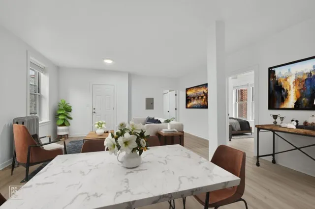 a living room with furniture kitchen view and a flat screen tv