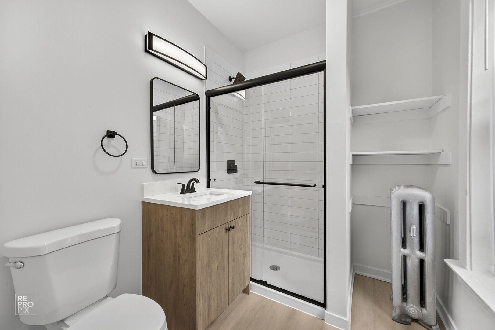 6975 North Bell Avenue, Unit 1 Chicago, IL 60645 - Photo 10 of 16 a bathroom with a sink a toilet and a mirror