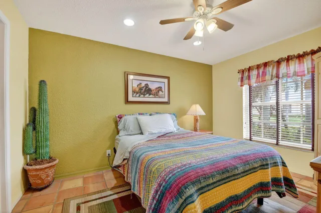 a bedroom with a bed and a painting on the wall