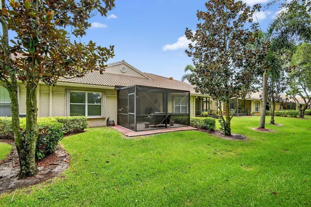 a view of a house with backyard sitting area and garden