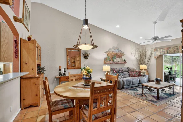 a living room with furniture a chandelier and a table