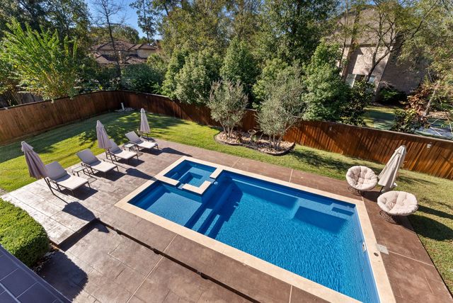 a view of yard from deck with patio