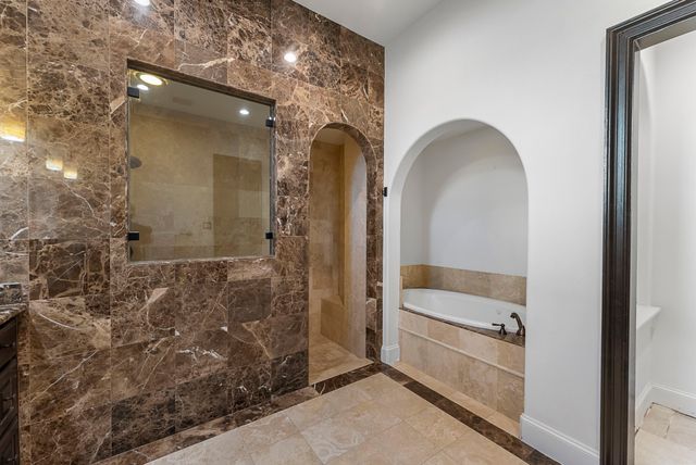 a bathroom with a tub and shower