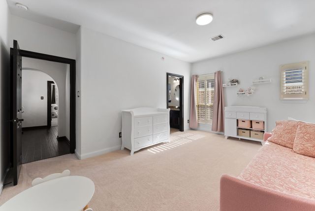 a living room with furniture and a bathroom