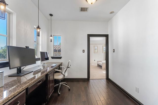 a view of a workspace with furniture and wooden floor