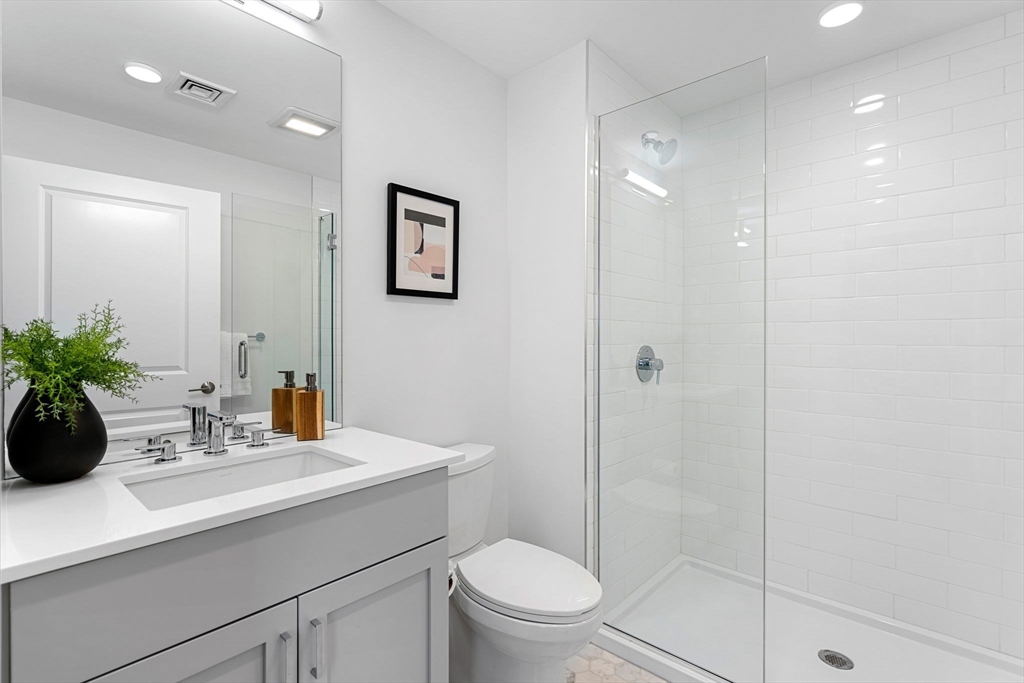 30 Polk Street, Unit 208 Boston, MA 02129 - Photo 15 of 30 a bathroom with a sink a toilet and shower