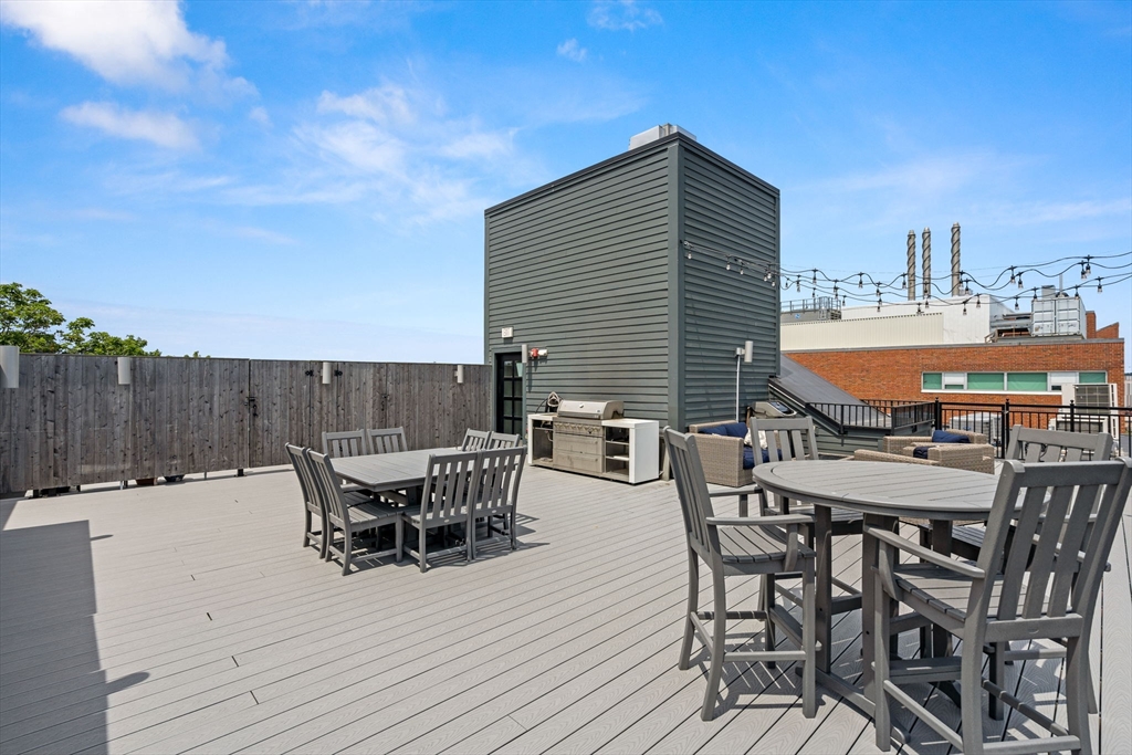 30 Polk Street, Unit 208 Boston, MA 02129 - Photo 20 of 30 a patio with table and chairs