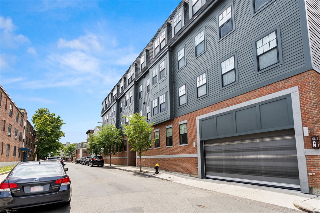 30 Polk Street, Unit 208 Boston, MA 02129 - Photo 30 of 30 a car parked in front of a building