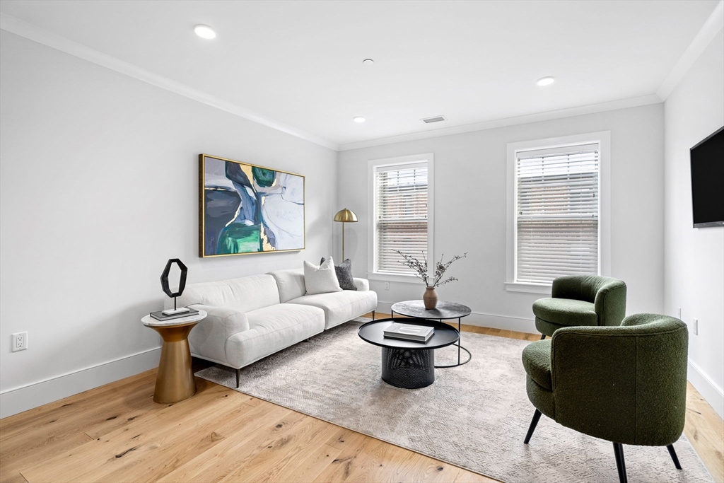 30 Polk Street, Unit 208 Boston, MA 02129 - Photo 6 of 30 a living room with furniture and a window
