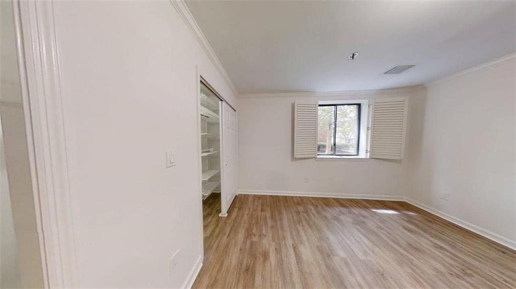 300 Johnson Ferry Road, Unit A112 Atlanta, GA 30328 - Photo 18 of 42 a view of a room with wooden floor and windows