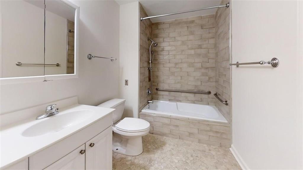 300 Johnson Ferry Road, Unit A112 Atlanta, GA 30328 - Photo 27 of 42 a bathroom with a sink a toilet and shower
