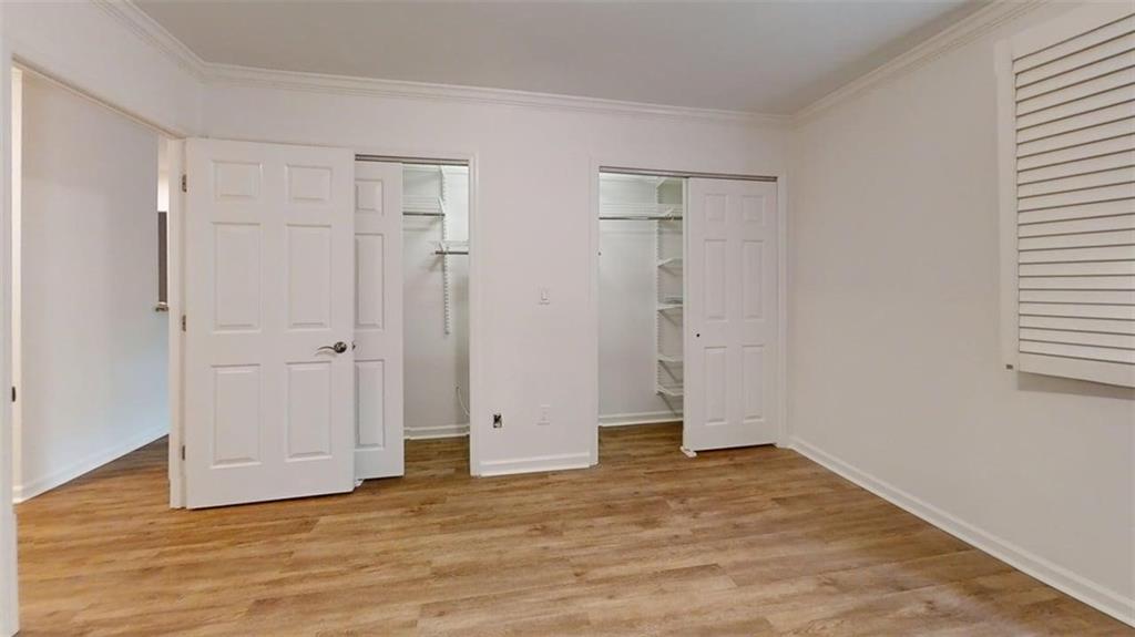 300 Johnson Ferry Road, Unit A112 Atlanta, GA 30328 - Photo 28 of 42 a view of an empty room with wooden floor and a window