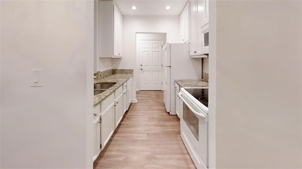 300 Johnson Ferry Road, Unit A112 Atlanta, GA 30328 - Photo 30 of 42 a kitchen with a sink and refrigerator