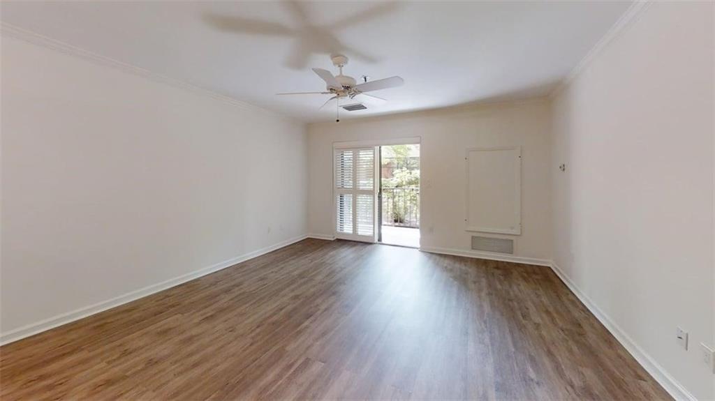 300 Johnson Ferry Road, Unit A112 Atlanta, GA 30328 - Photo 33 of 42 an empty room with wooden floor fan and windows