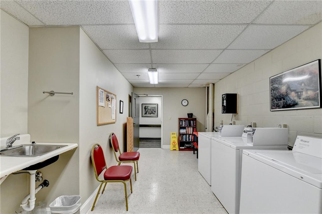 300 Johnson Ferry Road, Unit A112 Atlanta, GA 30328 - Photo 39 of 42 a living room with furniture and a flat screen tv