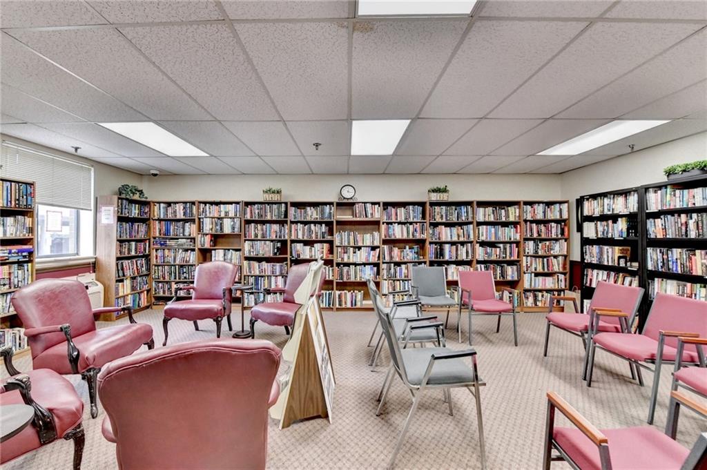 300 Johnson Ferry Road, Unit A112 Atlanta, GA 30328 - Photo 40 of 42 a work room with furniture a rug and a book shelf