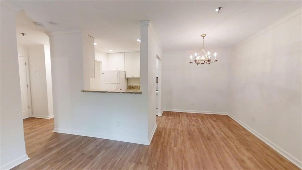 300 Johnson Ferry Road, Unit A112 Atlanta, GA 30328 - Photo 6 of 42 a view of livingroom with hardwood floor and kitchen view