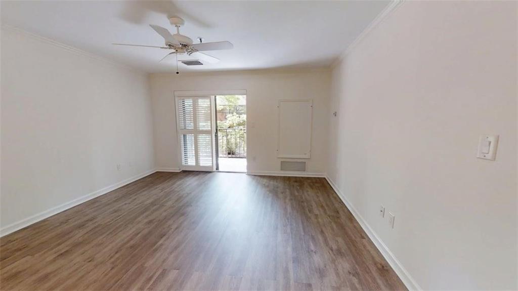 300 Johnson Ferry Road, Unit A112 Atlanta, GA 30328 - Photo 8 of 42 an empty room with wooden floor and windows
