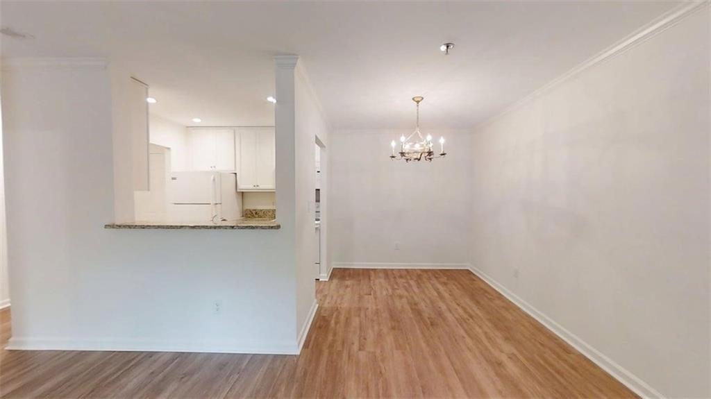 300 Johnson Ferry Road, Unit A112 Atlanta, GA 30328 - Photo 9 of 42 a view of a room with wooden floor and staircase