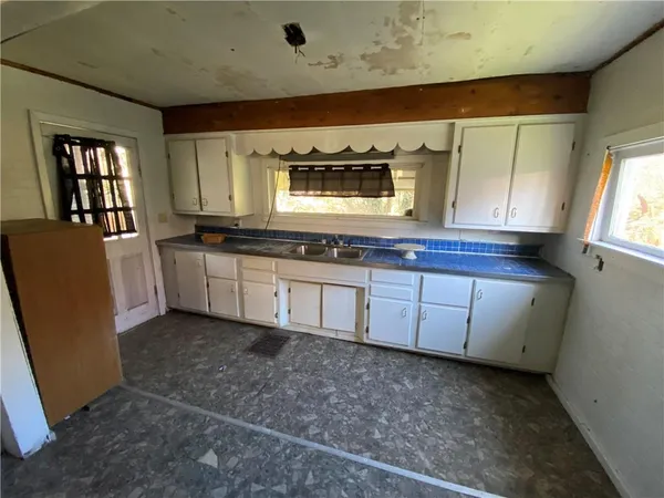 a kitchen with stainless steel appliances granite countertop a sink and a stove