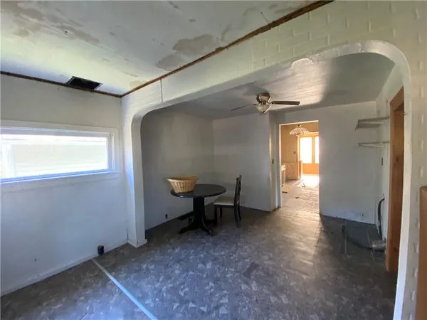 a view of a livingroom with wooden floor and a window