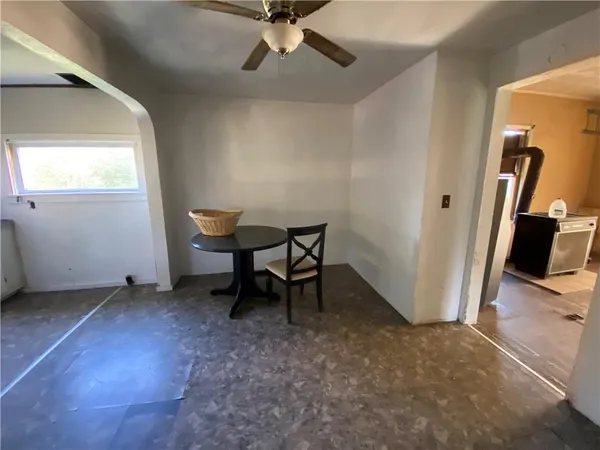 a view of a room with a window and wooden floor