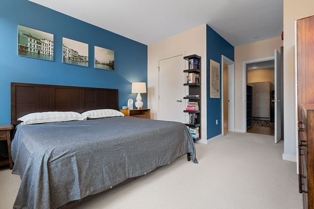 a bed sitting in a bedroom next to a lamp