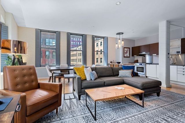 a living room with furniture and a table