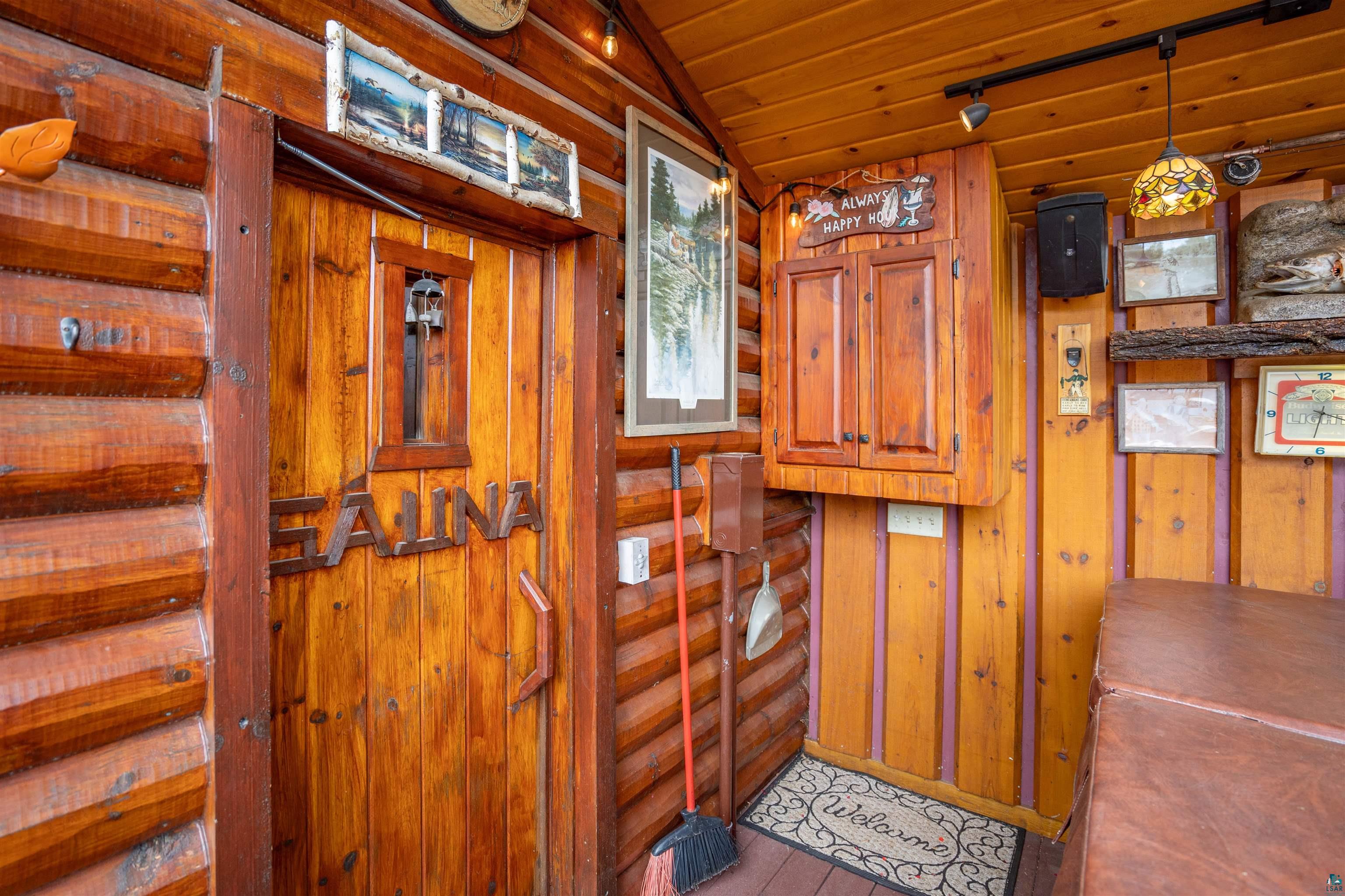 11911 East Rowe Road Lake Nebagamon, WI 54849 - Photo 36 of 61 Wood-paneled sauna door with decorative 'SAUNA' inscription