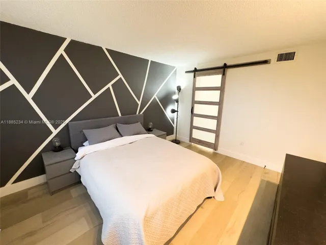 a bed sitting in a room next to a window