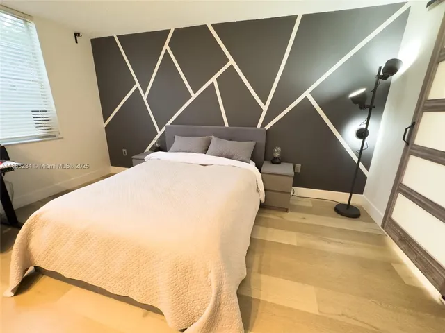 a bed room with a bed and a mirror