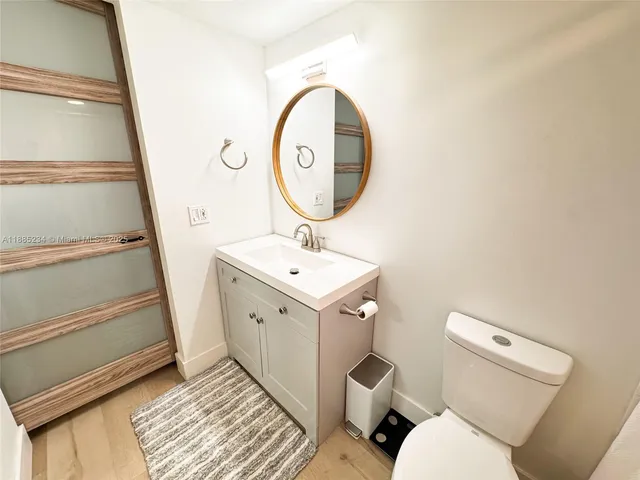 a bathroom with a toilet a sink and a mirror
