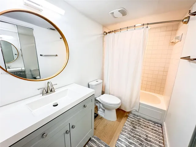 a bathroom with a sink toilet a mirror and vanity
