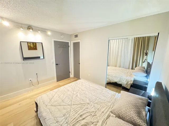 a bedroom with a large bed and a couch