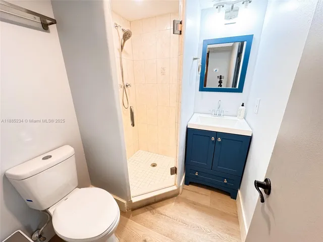 a bathroom with a toilet sink and a mirror