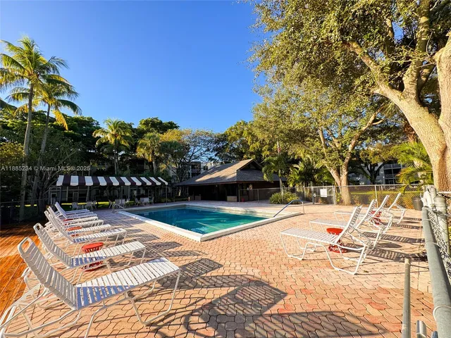 a view of swimming pool with lounge chair