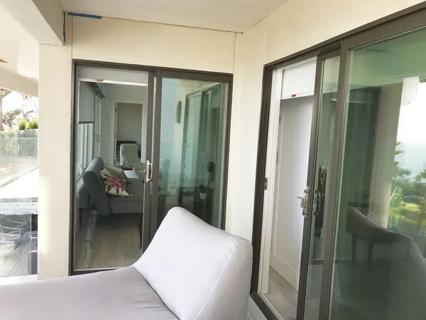 a bedroom with a bed and a large window