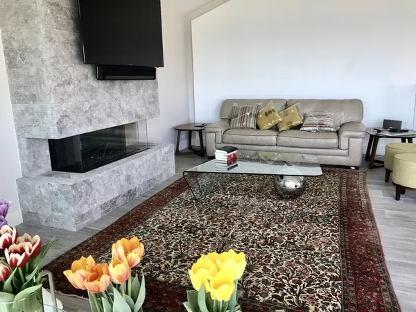 a balcony with table and chairs