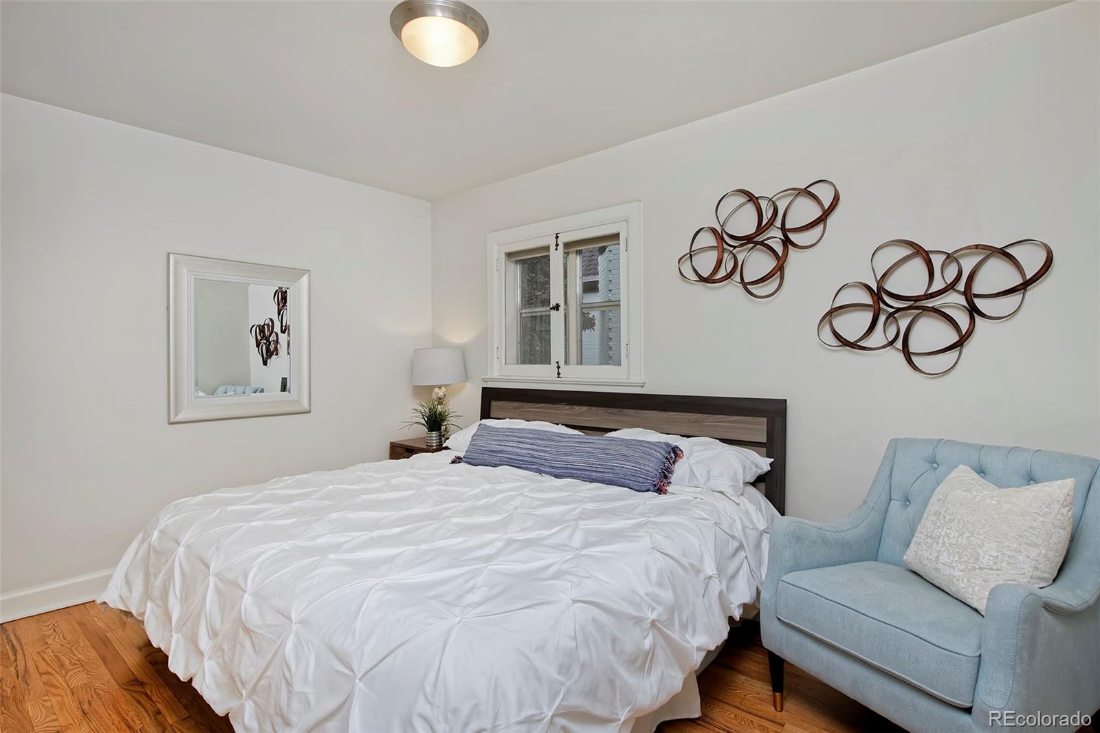 1674 Cherry Street Denver, CO 80220 - Photo 11 of 31 a bedroom with a large bed and a couch