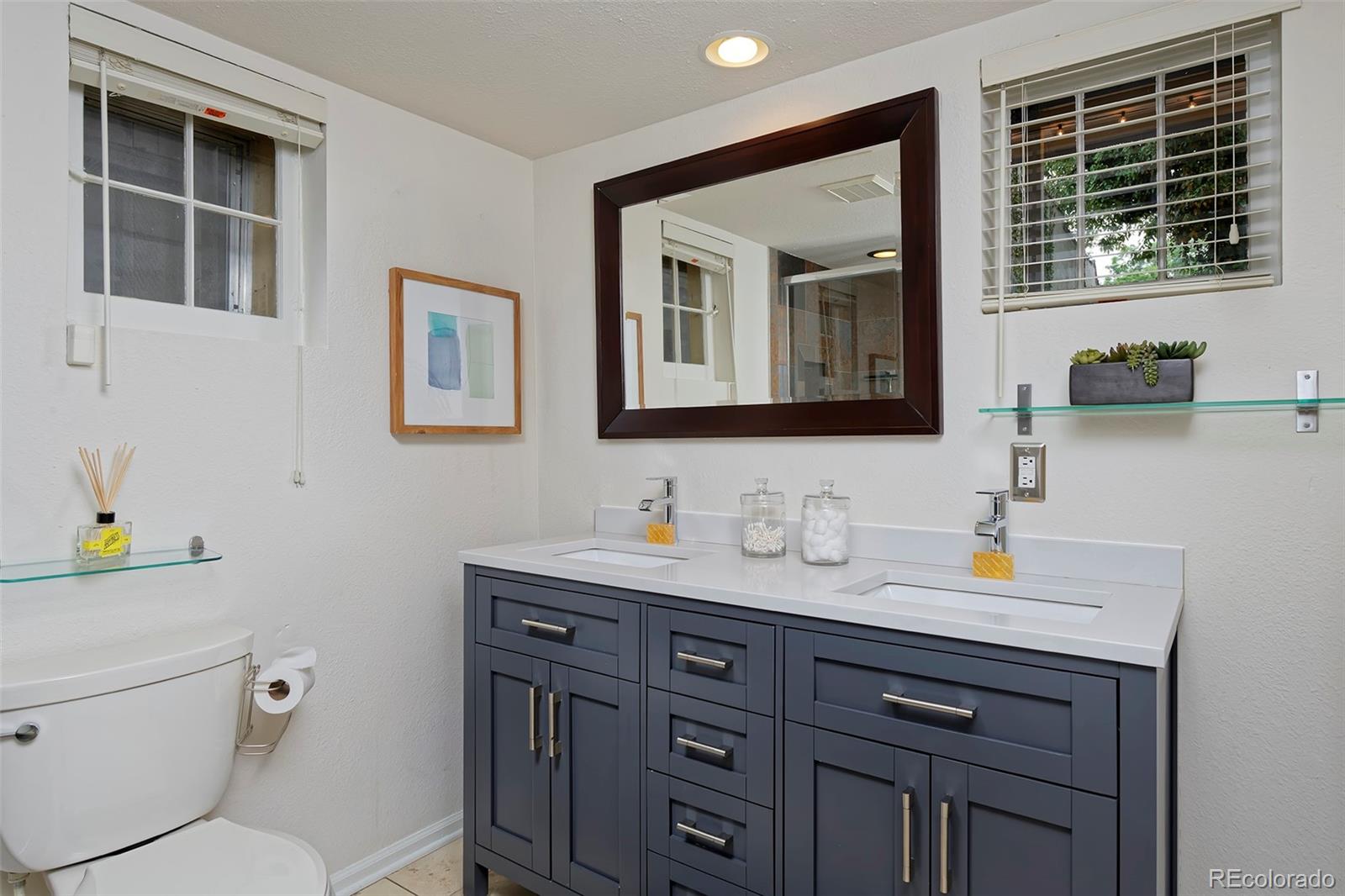 1674 Cherry Street Denver, CO 80220 - Photo 19 of 31 a bathroom with a toilet a sink and a window